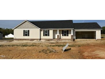 Charming single-Gathering home with a two-car garage, neutral siding, and black shutters at 59 N Movado Trl, Kenly, NC 27542