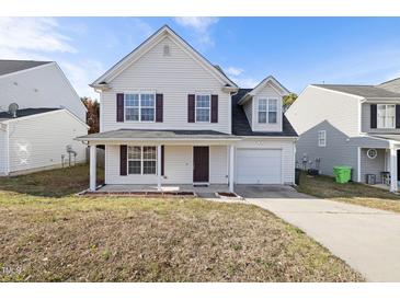 Charming two-story home with a covered front porch and attached garage at 1420 Springshire Ct, Raleigh, NC 27610