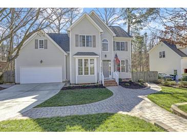 Charming two-story home featuring a well-manicured lawn, brick walkway, and attached two car garage at 1600 Patterson Grove Rd, Apex, NC 27502