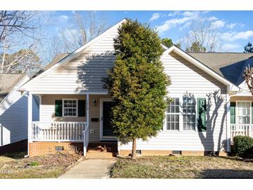 Charming home with a cozy front porch and well-maintained landscaping at 1614 W Cotton Gin Dr, Clayton, NC 27527