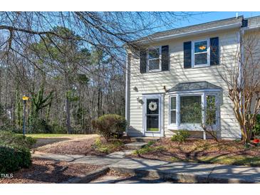 Charming townhome exterior featuring a well-manicured lawn and cozy front porch with tasteful decor at 174 St. Andrews Ln, Chapel Hill, NC 27517