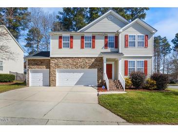 Charming two-story home featuring a stone accent wall, red shutters, and a well-maintained lawn at 211 Whitney Ln, Durham, NC 27713