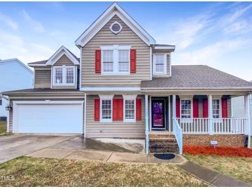 Charming two-story home with a well-manicured front yard and attached garage at 5317 Tifton Dr, Raleigh, NC 27610