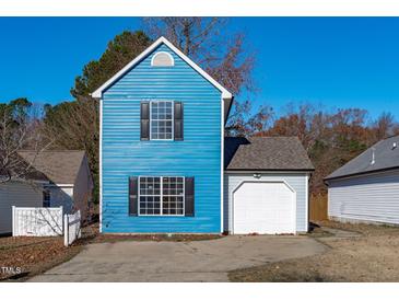 Charming blue two-story home with a white garage door and black window shutters at 605 Stratton Way, Durham, NC 27704