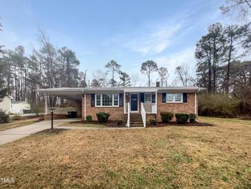 Charming brick home with a covered carport and well-maintained landscaping at 623 Sybil Dr, Durham, NC 27703