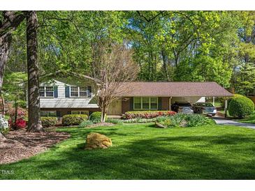 Charming home with a well-manicured front yard, lovely landscaping, and a convenient carport at 6504 Brandywine Rd, Raleigh, NC 27607
