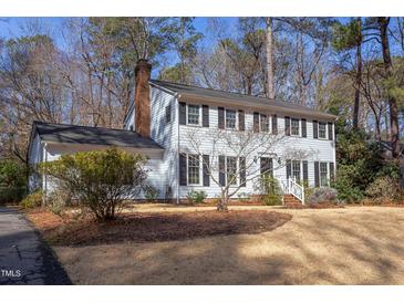 Traditional two-story home featuring black shutters and a brick chimney at 816 Churchill Dr, Chapel Hill, NC 27517