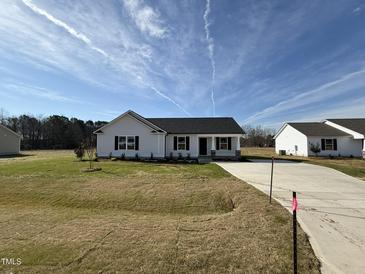 New construction shows charming one-story home with white siding, black shutters, and a well-manicured lawn at 90 Pate Landing Dr, Selma, NC 27576