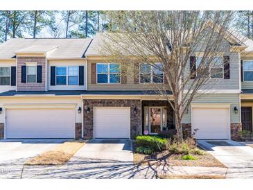 Attractive townhomes featuring stone accents and well-maintained landscaping in a quiet neighborhood at 107 Vickery Hill Ct, Durham, NC 27703
