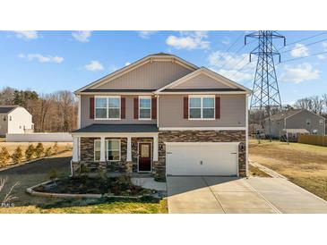 Charming two-story home with a two-car garage and stone accents at 110 Lodgepole Ln, Burlington, NC 27215
