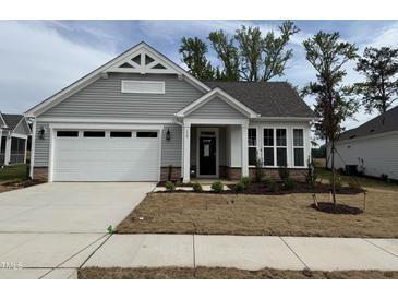 Charming single Gathering home featuring a two-car garage, black trimmed windows, and craftsman style details at 138 Oban Dr, Homesite 134, Sanford, NC 27330