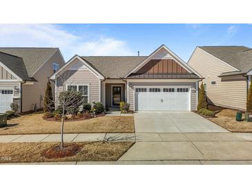 Charming single-story home features a two-car garage and inviting, landscaped front yard at 1435 Monterey Bay Dr, Wake Forest, NC 27587