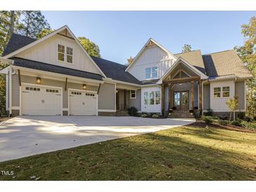 Charming two-story home with a two car garage, inviting entry, and manicured lawn at 25 Blackhorn Ct, Pittsboro, NC 27312
