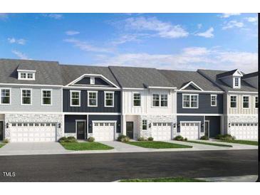 Charming townhome exteriors with a mix of light and dark facades and attached garages at 8717 Wardle Ct, Raleigh, NC 27616