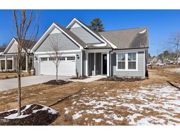 Charming single-story home with a well-maintained lawn and attached two-car garage at 2321 Calluna Ct, Fuquay Varina, NC 27526