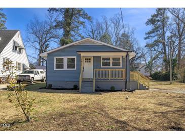 Charming blue home with a quaint front porch and well-maintained landscaping at 2611 Atlantic St, Durham, NC 27707
