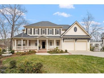 Charming two-story home featuring a welcoming front porch and a two-car garage at 302 Edinburgh Dr, Cary, NC 27511