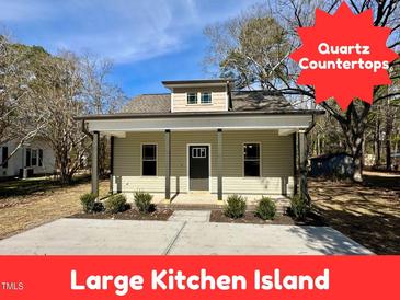 Charming single story home boasts a covered front porch and newly landscaped front yard at 315 S Maple Ave, Kenly, NC 27542