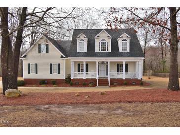 Charming home with welcoming front porch, dormer windows and manicured landscaping at 730 Duck Pond Rd, Nashville, NC 27856