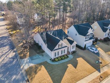 Charming two-story home with a well-manicured lawn, long driveway, and mature trees at 1700 Gracechurch St, Wake Forest, NC 27587