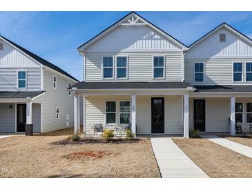 Charming two-story townhouse with a welcoming front porch and well-maintained lawn at 3010 Garner Rd # 102, Raleigh, NC 27610