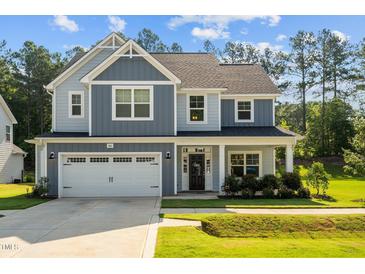 Charming two-story home with a manicured lawn, attached two car garage, and beautiful curb appeal at 340 Olde Liberty Dr, Youngsville, NC 27596
