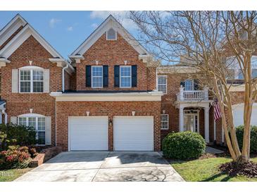 Charming brick two-story home featuring a two-car garage, manicured lawn, and inviting entrance at 3924 Sunset Maple Ct, Raleigh, NC 27612