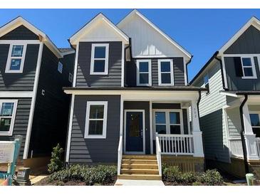 Charming two-story home with a modern exterior, inviting front porch, and freshly landscaped yard at 502 Yeowell Dr, Chapel Hill, NC 27514