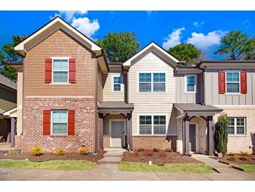 Charming townhomes featuring brick and siding exteriors and colorful shutters under a bright sky at 736 Wickham Ridge Rd, Apex, NC 27539