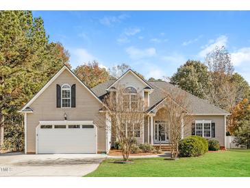 Charming single-Gathering home featuring a two-car garage and well-manicured lawn at 215 Oak Island Ct, Garner, NC 27529