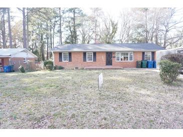 Charming one-story brick home with mature trees and a spacious front yard at 2918 Kanewood Dr, Durham, NC 27707