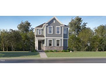 Charming two-story home featuring stone accents and traditional architectural details at 328 Canyon Spring Trl, Wake Forest, NC 27587