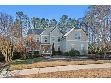 Charming two-story home with beautiful landscaping, neutral siding, and a welcoming entrance at 504 Crooked Pine Dr, Cary, NC 27519