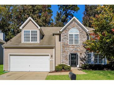 Charming two-story home featuring stone facade, attached garage, and well-maintained landscaping at 5129 Chasteal Trl, Raleigh, NC 27610