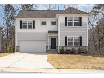 Charming two-story home with white siding, black shutters, and attached two car garage at 5439 Ripplebrook Rd, Durham, NC 27712