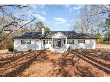 Charming single-story home with a well-maintained yard and inviting front porch at 7722 Nc 27 W, Lillington, NC 27546