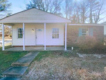 Charming single-story home featuring a covered front porch and a mix of siding and brick accents at 1216 Armstrong Cir, Raleigh, NC 27610