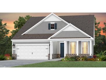 Charming two-story home with gray siding, white trim, a two-car garage and manicured landscaping at 1808 Angelonia Way, Fuquay Varina, NC 27526