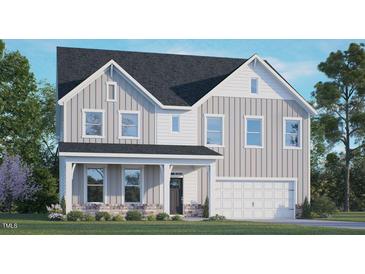 Charming two-story home featuring white vertical siding, black roof, and a welcoming front porch at 273 Umstead St, Sanford, NC 27330