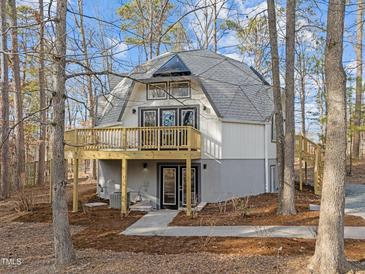 Unique dome-shaped home with a large deck and mature trees surrounding the property at 419 Obie Dr, Durham, NC 27713