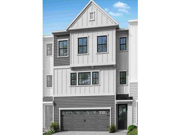 Charming two-story home featuring a gray two-car garage and a beautifully designed facade at 4507 Mint Leaf Ln, Raleigh, NC 27612