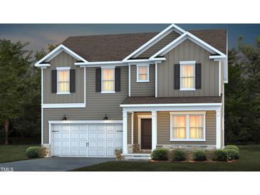 Charming two-story home featuring a two-car garage, neutral siding, and a welcoming front porch at 724 Denburn Pl, Raleigh, NC 27603