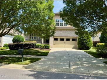 Charming two-story brick home with well-manicured lawn and inviting curb appeal at 1324 Vanagrif Ct, Wake Forest, NC 27587