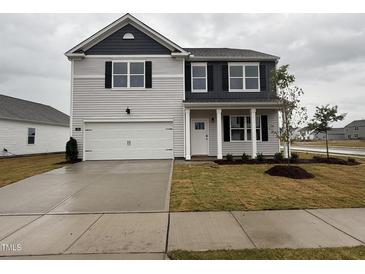 Charming two-story home with a two-car garage and professionally landscaped front yard at 150 Ethel Ln, Angier, NC 27501