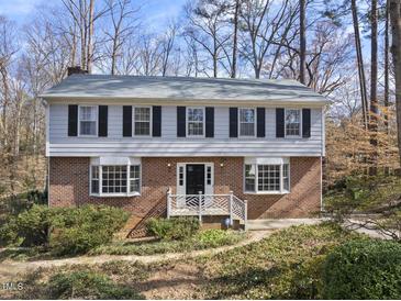 Charming two-story brick home featuring symmetrical design and manicured landscaping at 2004 Beecham Cir, Raleigh, NC 27607