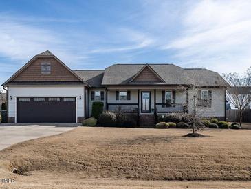 Charming single-story home with an attached two-car garage and covered front porch at 30 Imperial Dr, Clayton, NC 27527