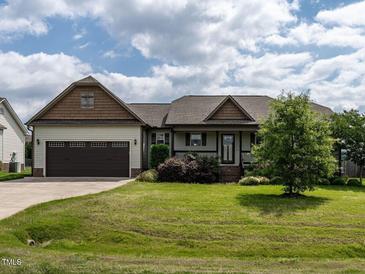 Charming single-story home with a well-manicured lawn, attached garage and inviting front entrance at 30 Imperial Dr, Clayton, NC 27527