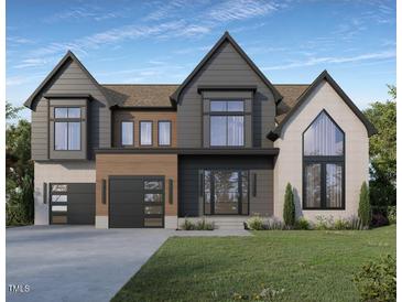New construction with a modern design, featuring a two car garage and complementary colored construction materials at 405 Latimer Rd, Raleigh, NC 27609