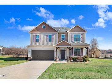 Charming two-story home featuring two-tone paint, a two-car garage, and a well-manicured front yard at 500 Wakefield Dr, Princeton, NC 27569