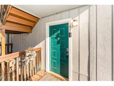 Inviting teal front door with security features and unit number displayed above the door at 5816 Pointer Dr # 102, Raleigh, NC 27609